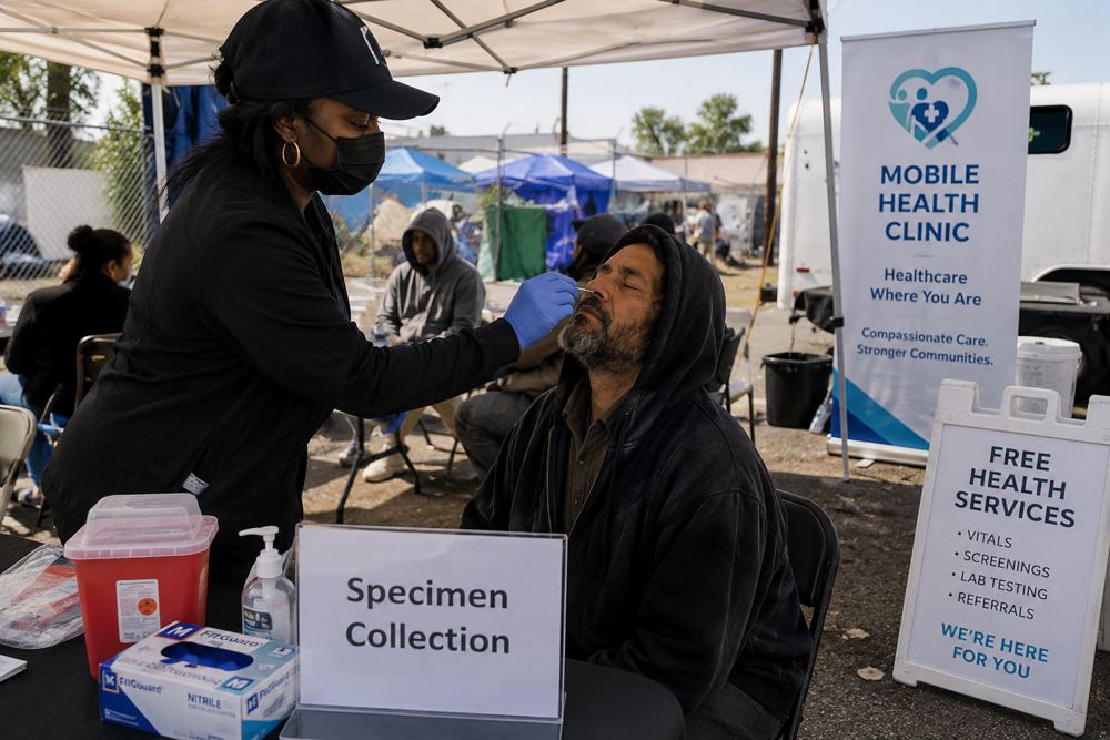 Field staff performing specimen collection at mobile outreach site