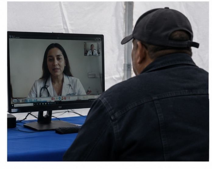 Patient consulting with doctor via telehealth at mobile outreach site